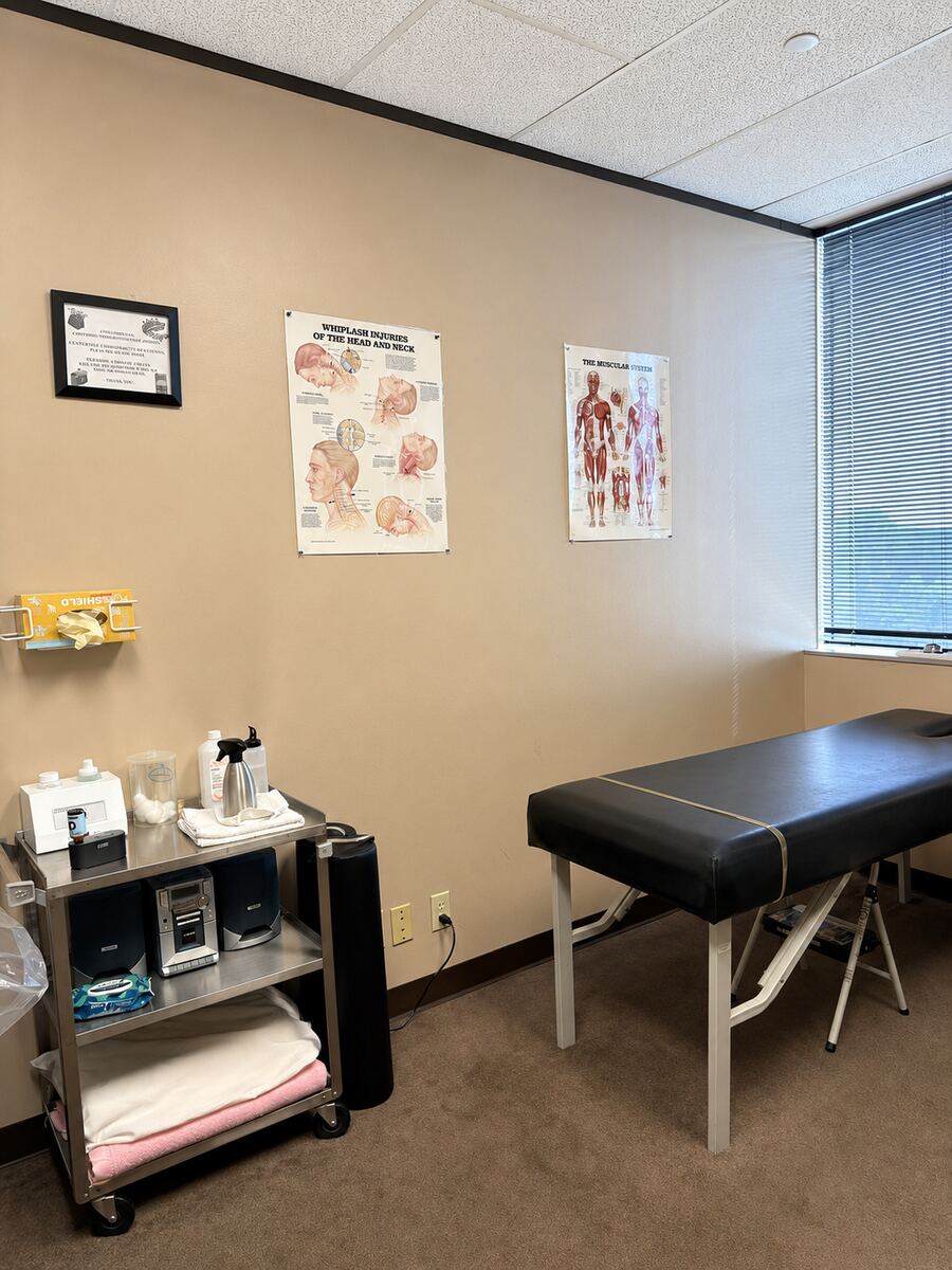 Exam room with treatment table and supply cart